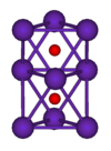 The ball-and-stick diagram shows two regular octahedra which are connected to each other by one face. All nine vertices of the structure are purple spheres representing rubidium, and at the centre of each octahedron is a small red sphere representing oxygen.